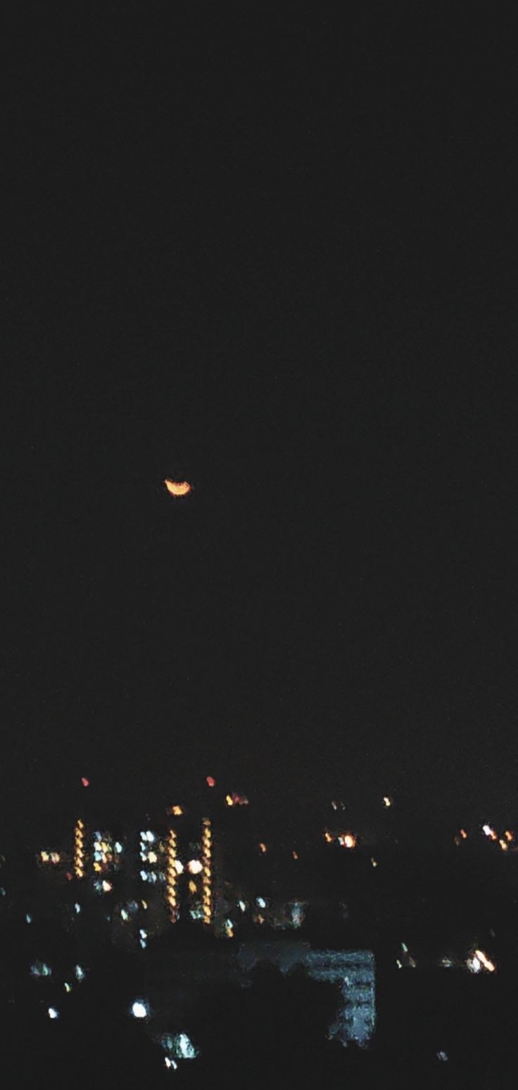 an airplane flying over the city at night