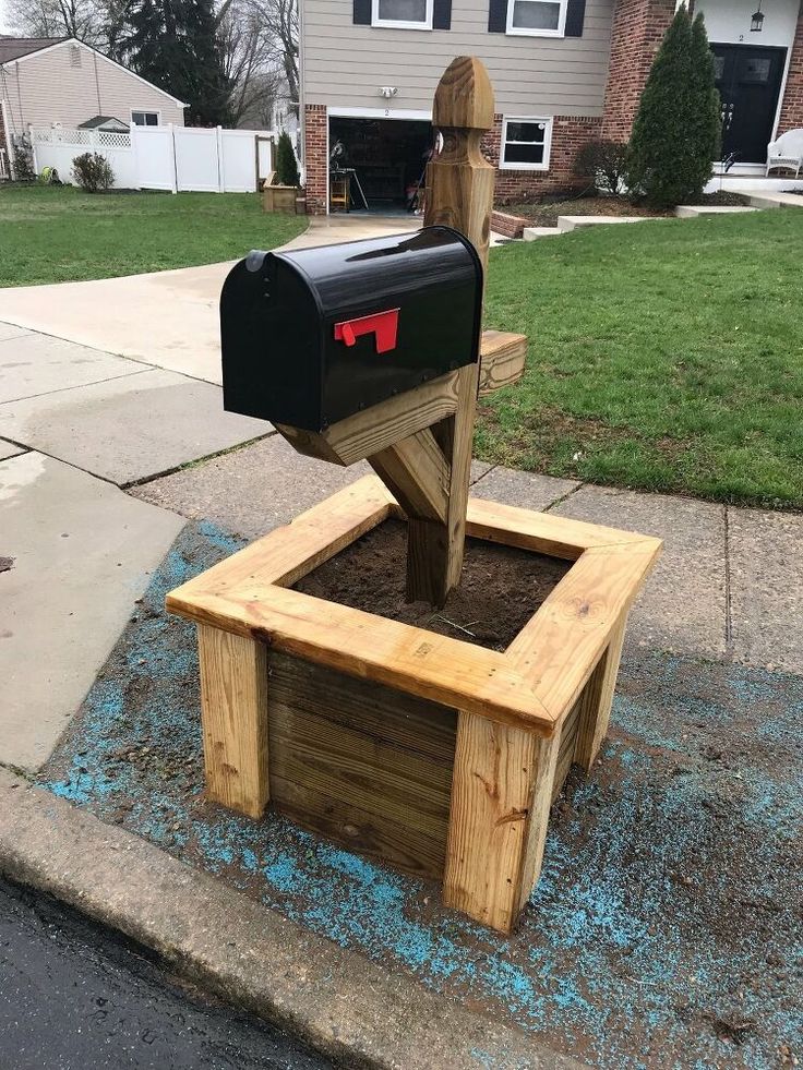 a mailbox sitting on top of a wooden bench