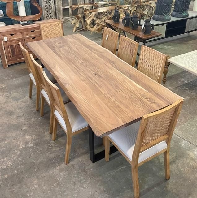 a large wooden table surrounded by chairs and other furniture