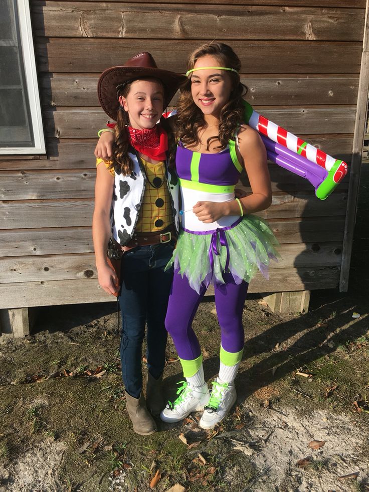 two girls dressed up in costumes standing next to each other