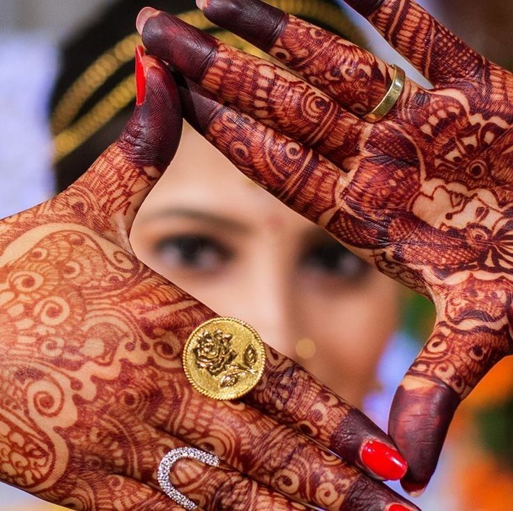 a close up of a person's hands with hennap and ring on it