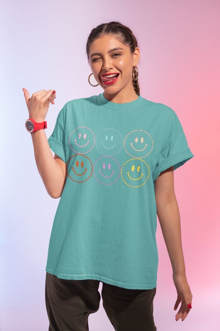 Smiley Face Vintage Shirts Women Happy Face Tshirt Smile Tee Shirt Vintage Comfy Tee Women's Shirts Comfort Colors Distressed Trendy Shirt 📦 FREE SHIPPING on orders $35 or more to US shoppers 🛒Our unisex distressed Smiley Face T-Shirts are a soft relaxed/loose fitting t-shirt, perfect for lounging around the house, relaxing or running errands. 👕Brand = Comfort Colors 🧵Fabric = 100% Cotton ✂️Design = Heat-applied vinyl (Distressed vinyl design) 🎨Color = Seafoam (Colors will vary from compute Fun Crew Neck Shirt With Screen Print, Cute Smiley Face Summer Tops, Cute Smiley Face Tops For Summer, Fun Smiley Face Tops, Funny Smiley Face Summer T-shirt, Cute Cotton Tops With Smiley Face, Fun Short Sleeve Tops With Smiley Face, Trendy Smiley Face Summer Tops, Playful Smiley Face Crew Neck Top