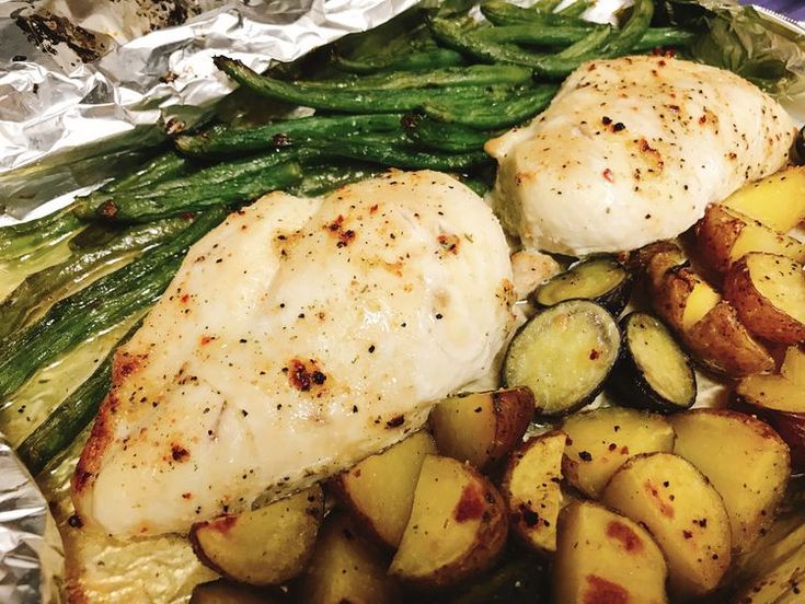 chicken, potatoes and green beans on tin foil