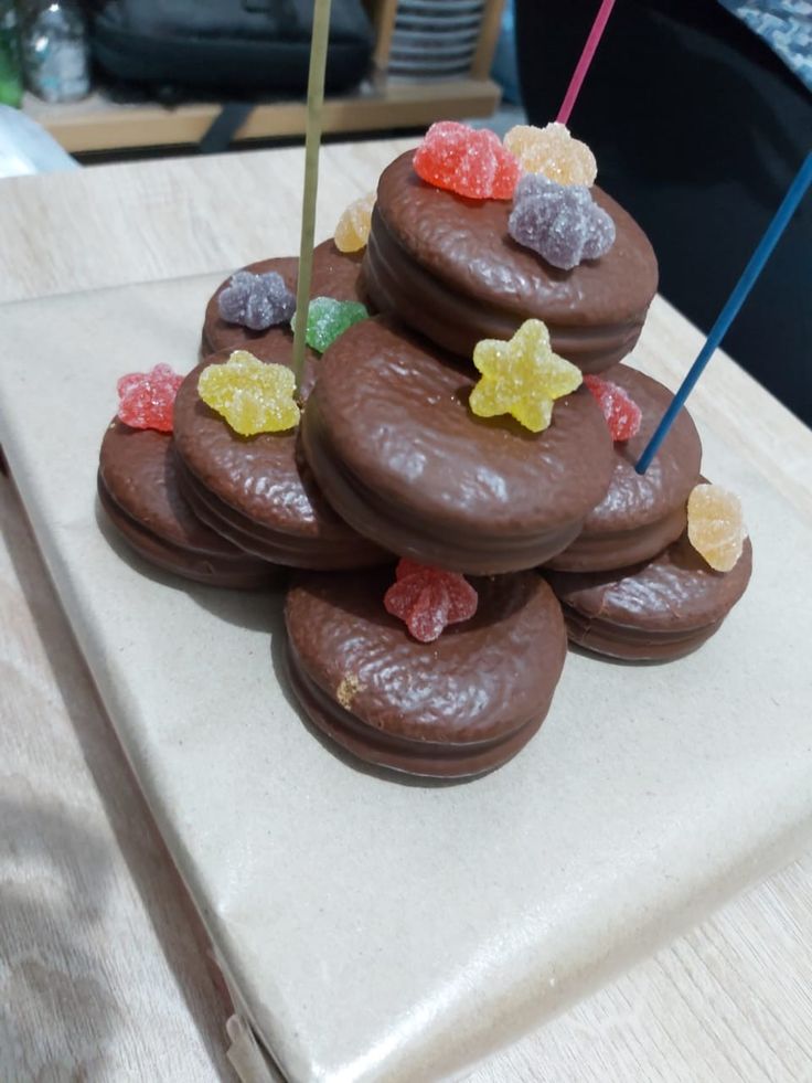 a stack of chocolate covered cookies sitting on top of a counter