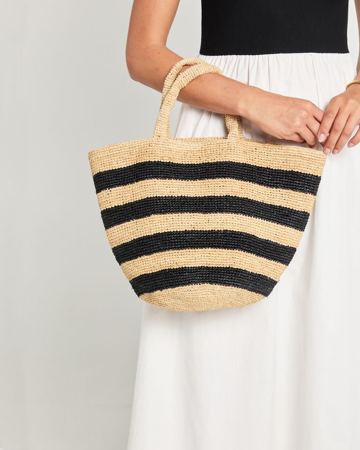 Product Details Introducing the Catania Handmade Raffia Bag - a perfect blend of natural yet chic style. With its black striped design and easy tote design, this handbag is both sophisticated and effortless. - Content: 100% Hand woven Madagascar raffia Style# DAN24KUANTIAO Please note this item is FINAL SALE. We will replace broken items when possible or offer a replacement for items damaged during shipping. Returns, refunds, or replacement products for reasons other than damage incurred during Raffia Basket, Tote Design, Crochet Beach Bags, Summer Fashion Accessories, Summer Tote Bags, Crochet Handbags Patterns, Raffia Bag, Net Bag, Straw Bags