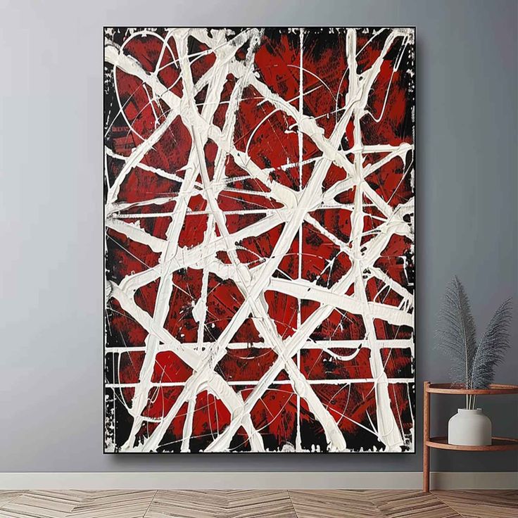 an abstract painting in red and white on a wall