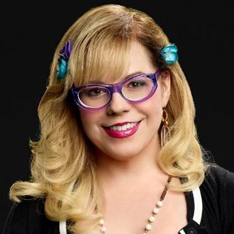 a woman wearing glasses with butterflies on her head and smiling at the camera while standing in front of a purple background