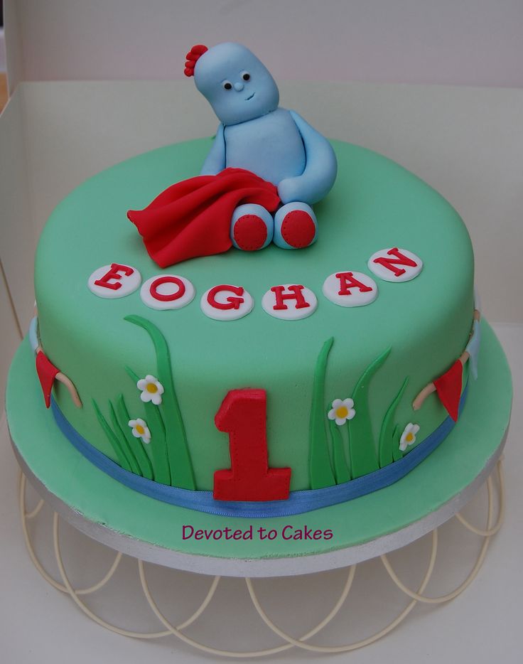 a birthday cake for a one year old boy with a blue teddy bear on top