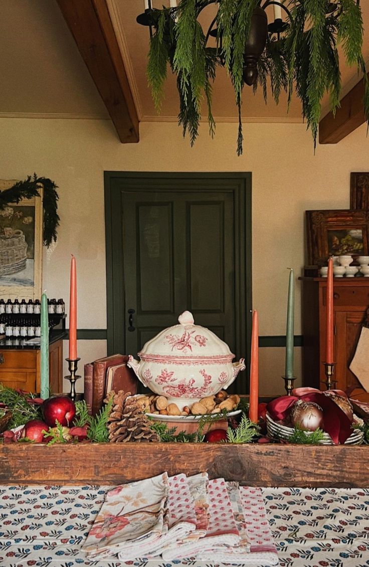 a table topped with lots of food next to a green door and potted plant