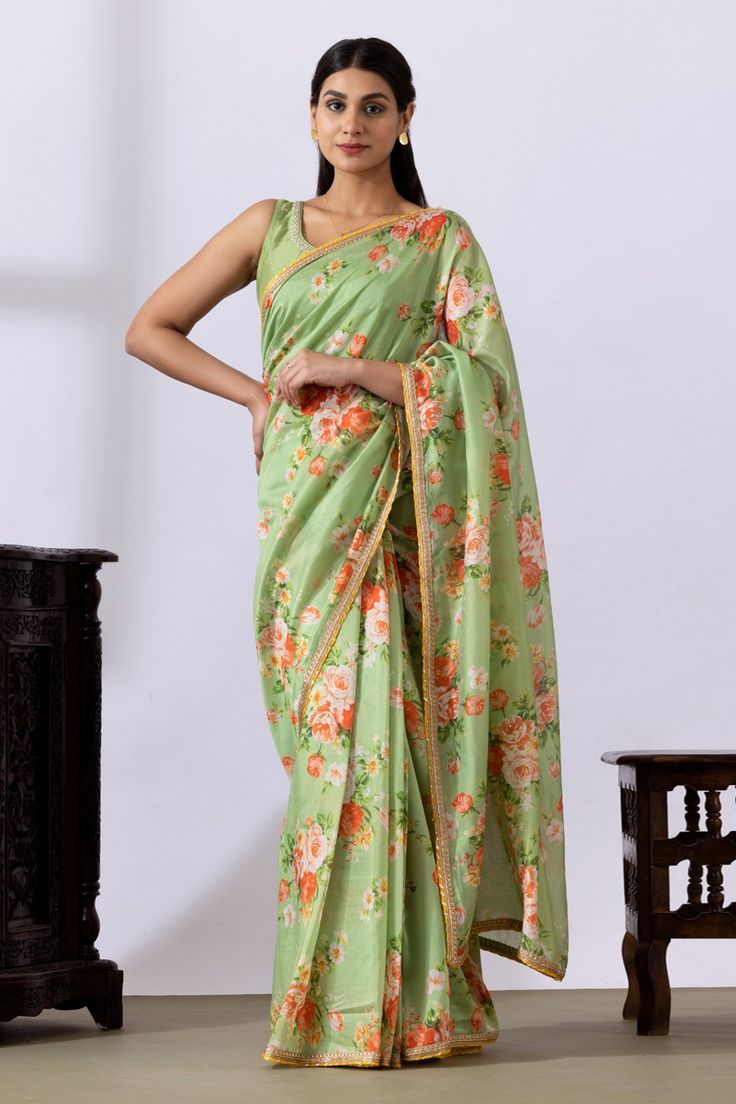 Pista green saree with floral digital prints and lace detailing. Paired with embroidered blouse.
Components: 2
Pattern: Printed, Embroidered
Type Of Work: Floral
Neckline: Round
Sleeve Type: Sleeveless
Fabric: Chanderi
Color: Green
Other Details: 
Lace detailing
Back tassel tie-up
Occasion: Puja - Aza Fashions Pista Green Saree, Saree Gowns, Cotton Sarees Handloom, Pista Green, Ruffle Saree, Drape Saree, Green Saree, Lehenga Saree, Blouse For Women