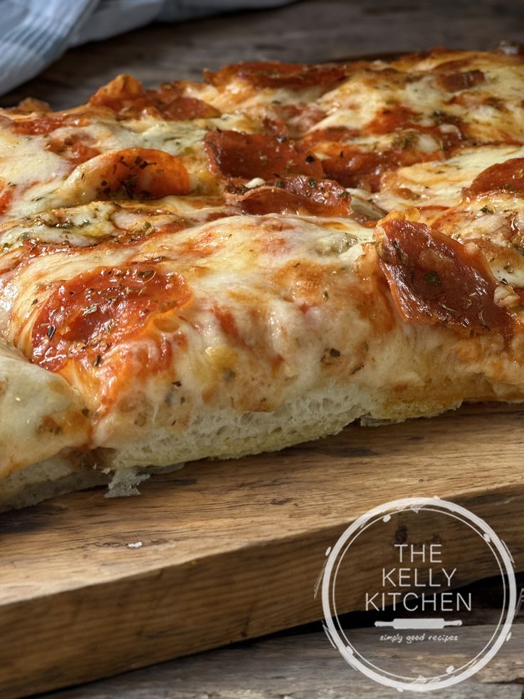 a pizza sitting on top of a wooden cutting board