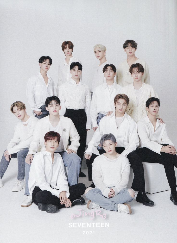 a group of young men sitting next to each other in front of a white background