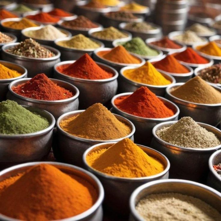 many bowls filled with different colored spices