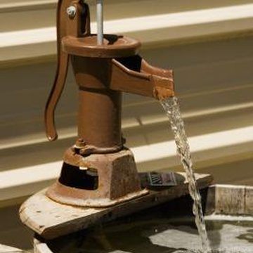 an old fashioned water pump is being filled with water