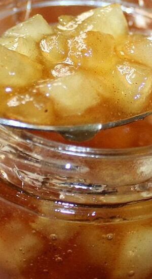 a glass jar filled with ice and some type of food on top of a table