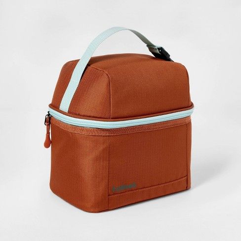 an orange lunch bag with blue trim on the front and side zippers, sitting against a white background