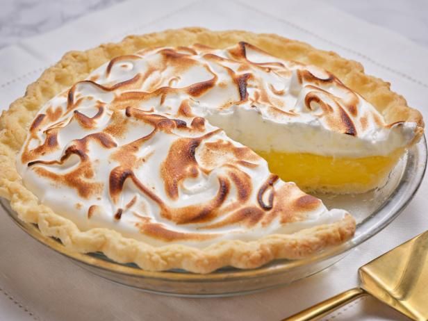 a lemon meringue pie with a slice missing