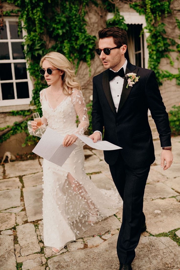 a man in a tuxedo walking next to a woman