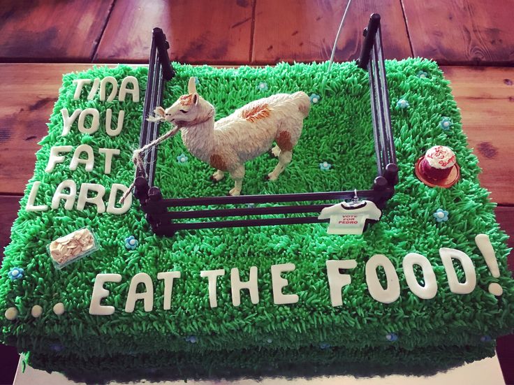 a cake that is shaped like a bed with sheep on it and the words eat the food