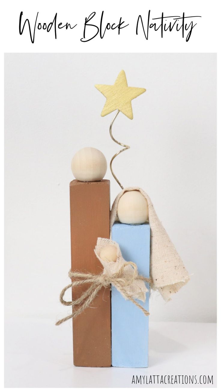 a wooden block nativity set with a star on top and two blocks stacked together