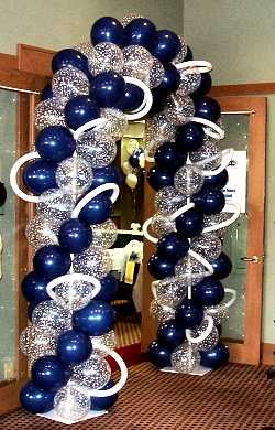 blue and silver balloon arch in an office hallway with white ribbon on the bottom half