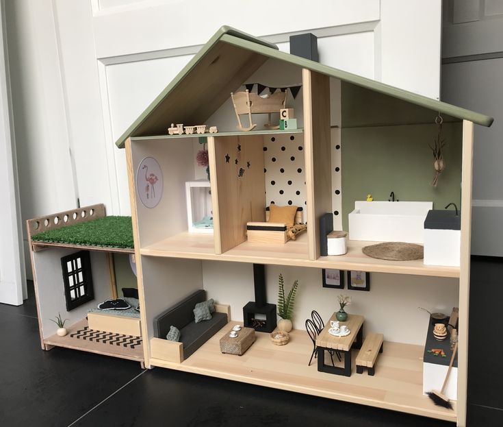 a doll house with furniture and accessories on display