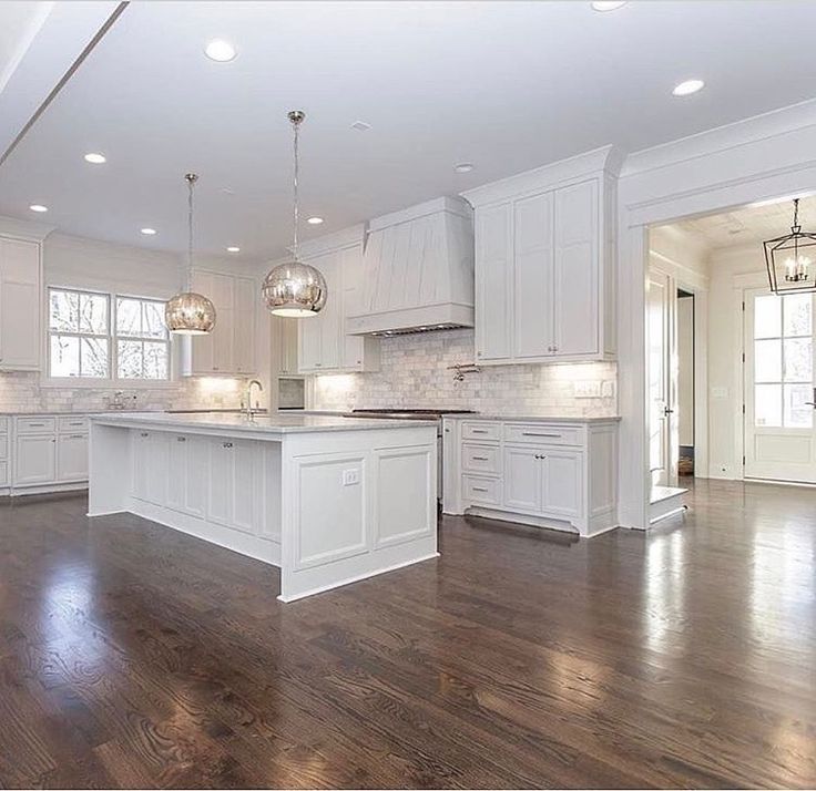 an empty kitchen with white cabinets and wood floors is pictured in this image from the inside