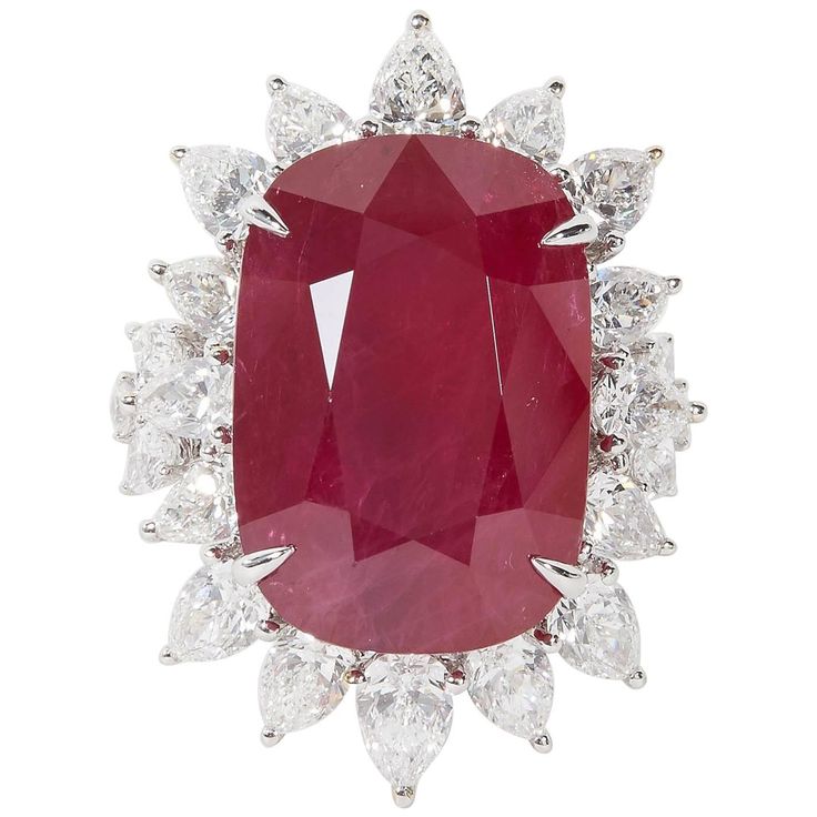 A rare find! Certified 24.64 carat cushion cut African Ruby with "intense red" color. The ruby is surrounded by 4.57 carats of pear shape diamonds. 18k Approximately 1.30 inches from its highest to lowest point, an inch wide. The ring is currently a size 7 but can easily be resized. Certified by C Dunaigre of Switzerland. A beautiful ruby ring! Antique Ruby Ring, Ruby And Diamond Ring, Vintage Cocktail Ring, Woman Jewelry, Ruby Diamond Rings, Ruby Pendant, Ruby Engagement Ring, Diamond Cocktail Rings, Vintage Cocktail