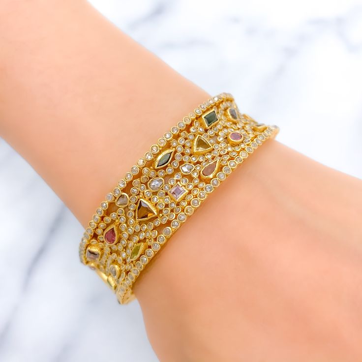 PRODUCT DETAILS Gold Purity(karat): 22k Item Weight(grams): 46.7 Item Finish: Yellow Gold Stone: Polki Diamond Diamond Weight(carats): 10.55ct Accented Stone: Tourmaline Stone Weight: 6.44ct Bangle Size: 2.4 Bangle Opening: 2.25" Openable: Yes, Hinge w/ Screw Gold Diamond Multi-stone Bracelets, Gold Diamond Bracelets With Multi-stones, Luxury 22k Gold Hand Set Bangle, Gold Bangle With Gemstone Accents, Gold Jeweled Fusion Bangle, Elegant Gold Bangle With Multi-stone Details, Elegant Gold Bangle With Multi-stone, Gold Fusion Style Jeweled Bangle, Yellow Gold Multi-stone Bangle For Wedding