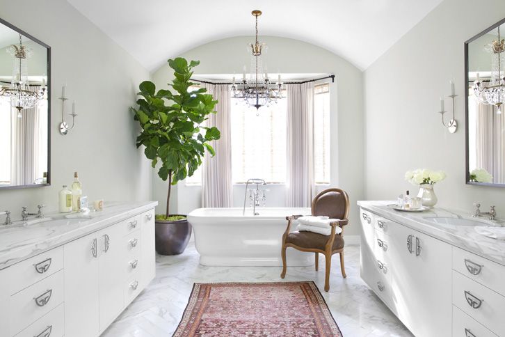 the bathroom is decorated in white and has a large rug on the floor next to it