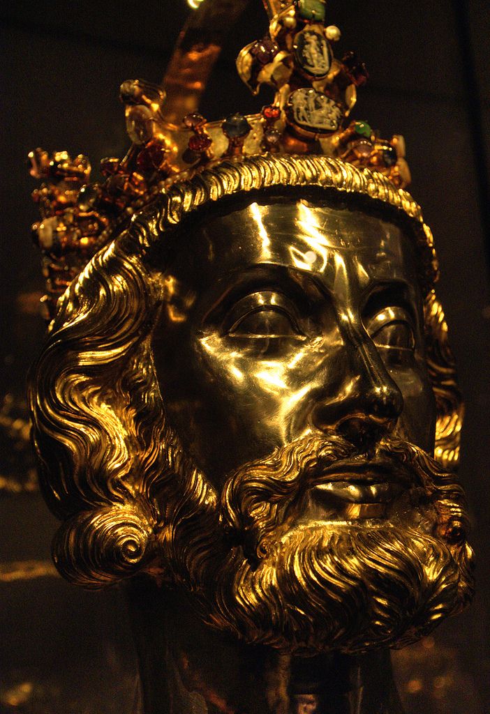 a gold statue with a crown on it's head