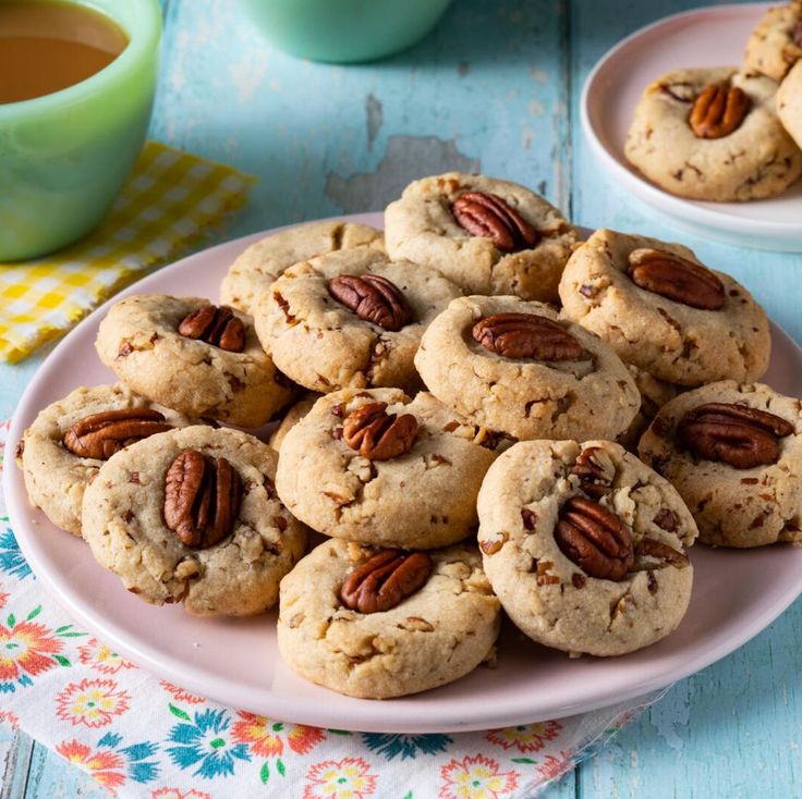 a plate full of pecan cookies on a table