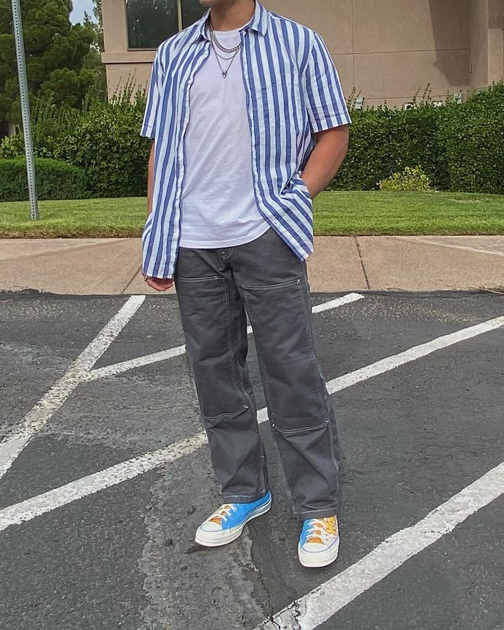 a man standing in the middle of a parking lot