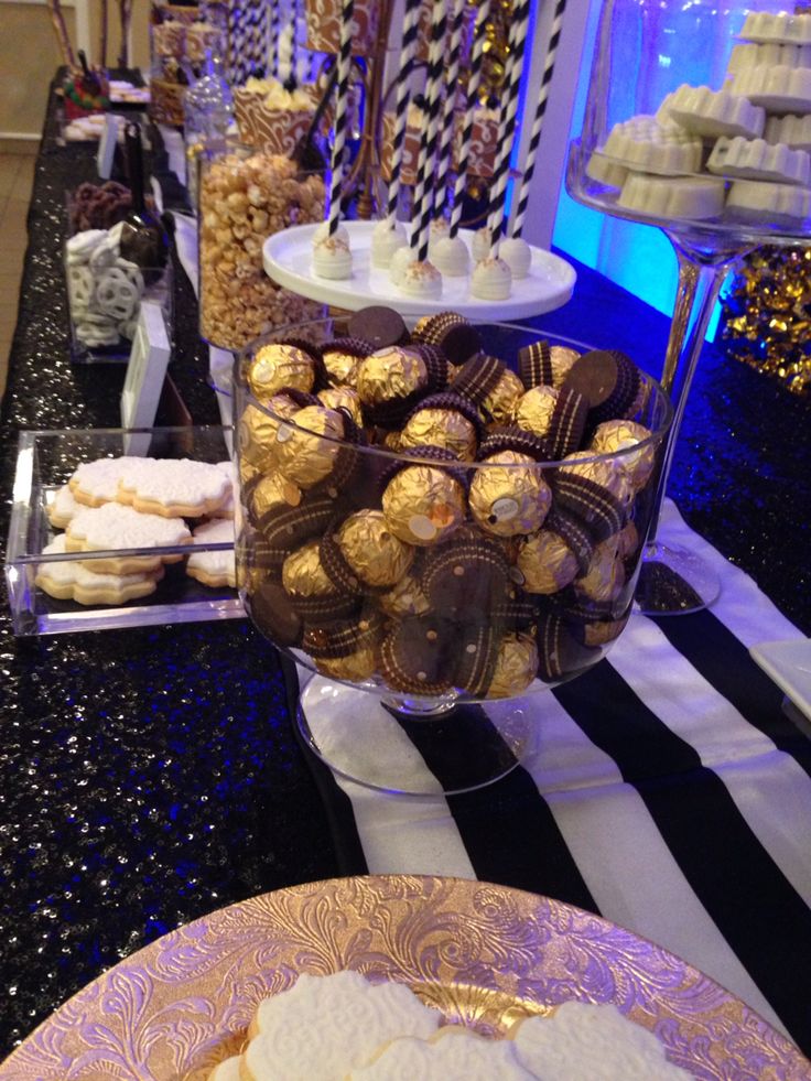 desserts and sweets displayed in glass containers on a table