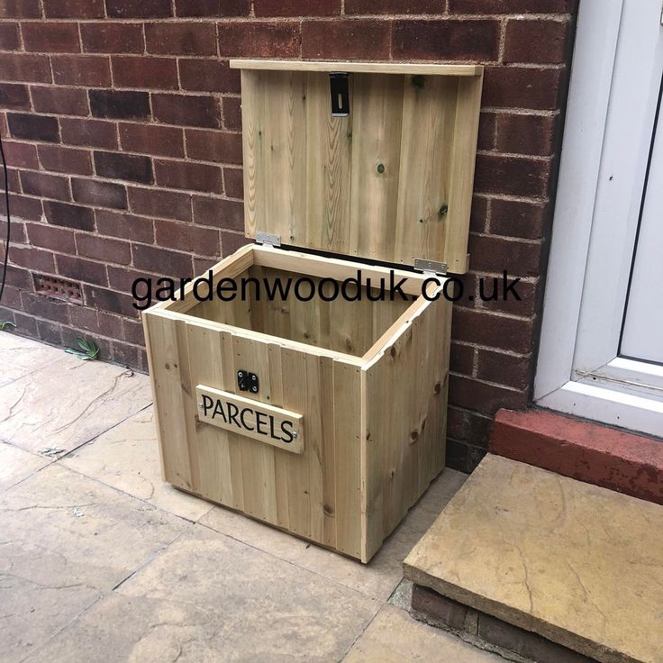 a wooden box sitting on the side of a building