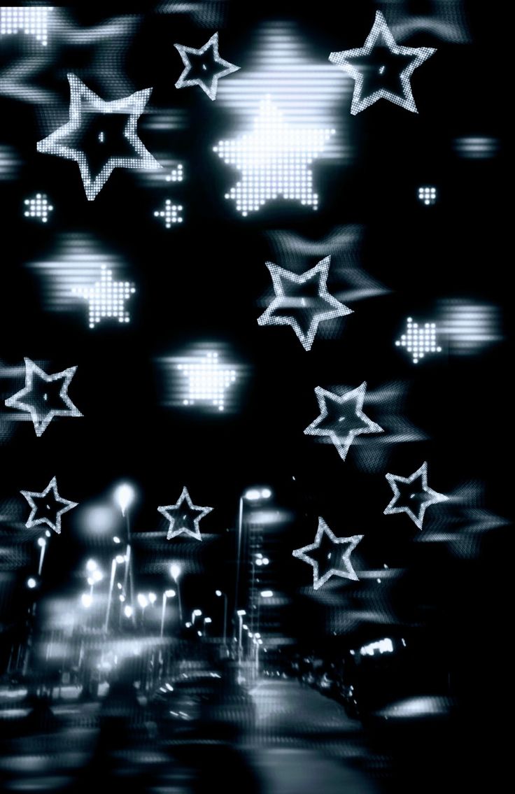 many stars are flying in the air over a city street