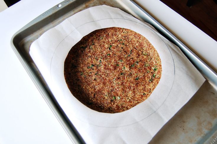 a round food item sitting on top of a metal pan next to a spatula