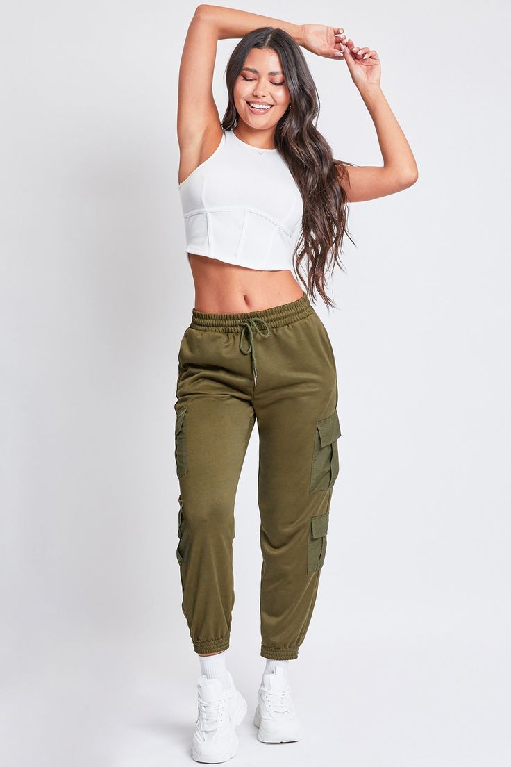 Keep it cute and casual in our Women’s Joggers with Nylon Pockets. These trendy mixed-media joggers are constructed with a soft, midweight polyester fabric and feature pleated flap cargo pockets made of parachute-style material. These lounge pants feature an elastic waist with drawstring closure, inseam front pockets, and an elastic hem. Style with a fitted tank and sneakers for an on-trend sporty vibe. Product Details- High-Rise- Elastic Waist with Drawstring Closure- Inseam Front Pockets- Doub Green Nylon Cargo Pants, Athleisure Style, Green Nylon Cargo Pants For Athleisure, Green Nylon Cargo Pants In Athleisure Style, Sporty Khaki Joggers With Pockets, Stretch Khaki Cargo Parachute Pants, Green Nylon Athleisure Cargo Pants, Khaki Cargo Style Joggers For Streetwear, Sporty Khaki Cargo Pants For Spring, Sporty Spring Khaki Cargo Pants