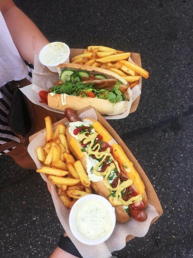 two hot dogs and french fries with ketchup, relish and mayonnaise