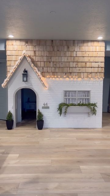 a dog house with plants and lights on the roof