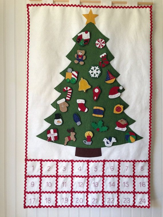 a christmas tree is hanging on the wall next to a calendar with pins and numbers