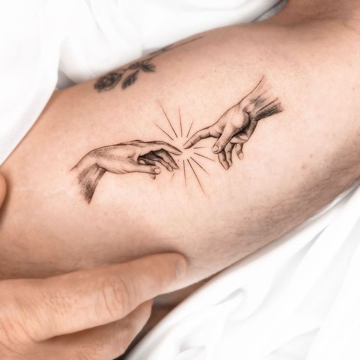 the creation of man's hands is depicted in this tattoo