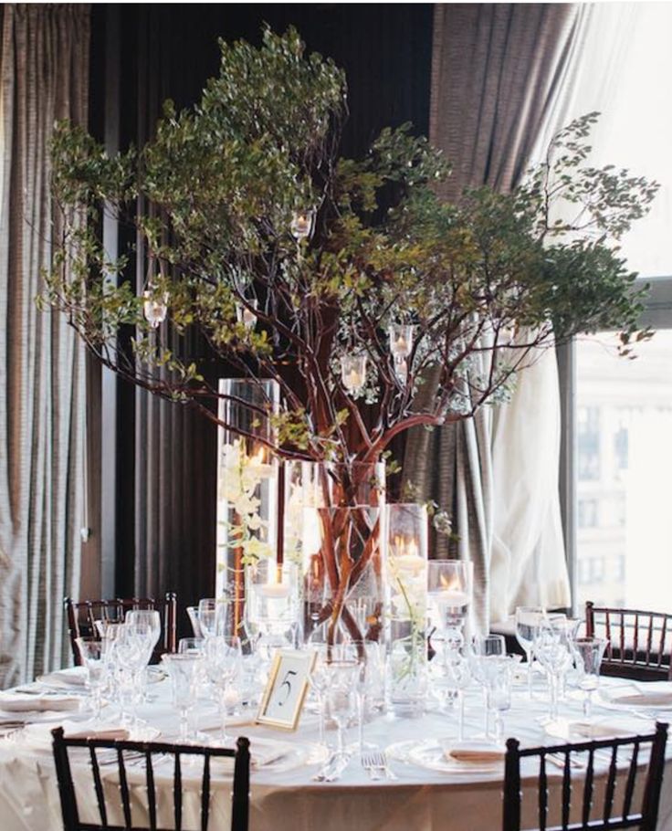 the table is set with many glasses and place settings