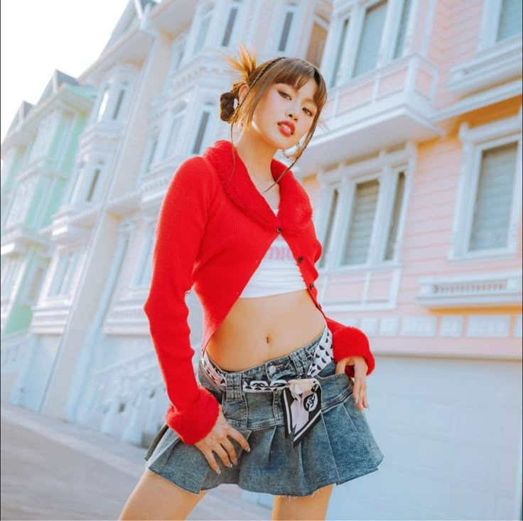 a young woman posing in front of a building