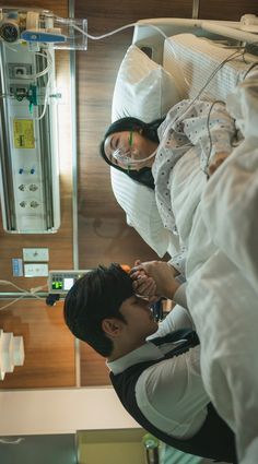 a man and woman in hospital gowns looking at each other