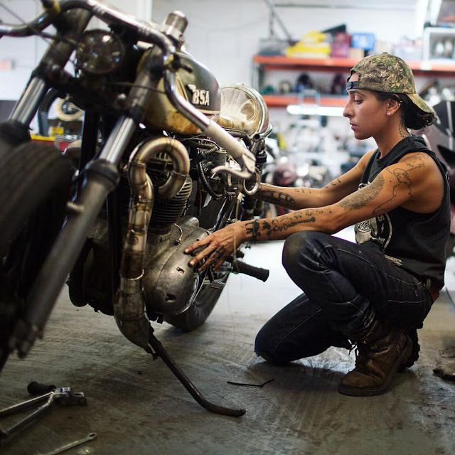 a man working on a motorcycle in a garage