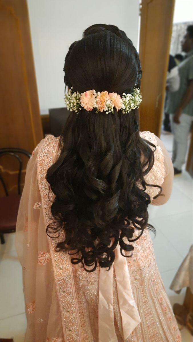 the back of a woman's head with flowers in her hair