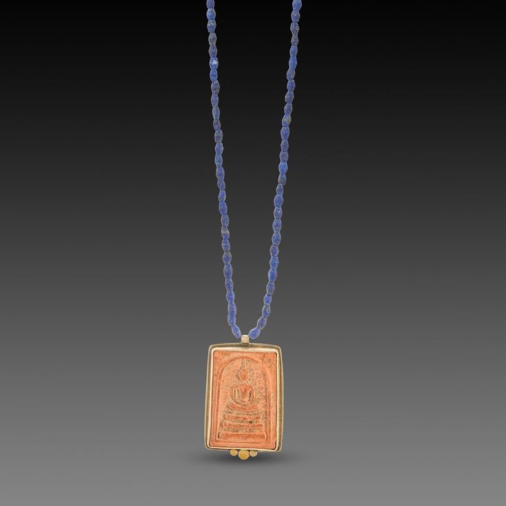 This softly weathered Thai Buddha amulet is set in sterling silver and highlighted by a warm 22k gold trio. The pendant, measuring approximately 7/8 inch x 1 1/4 inch, is suspended from an strand of deep blue, matte lapis beads, and secured with a sterling silver lobster clasp. Sterling silver back. Matte finish. Be inspired by this lovely symbol of wisdom and compassion. Thai Buddha, Talisman Pendant, Lapis Necklace, 22k Gold, Deep Blue, Lobster Clasp, Arrow Necklace, 4 Inch, Beads