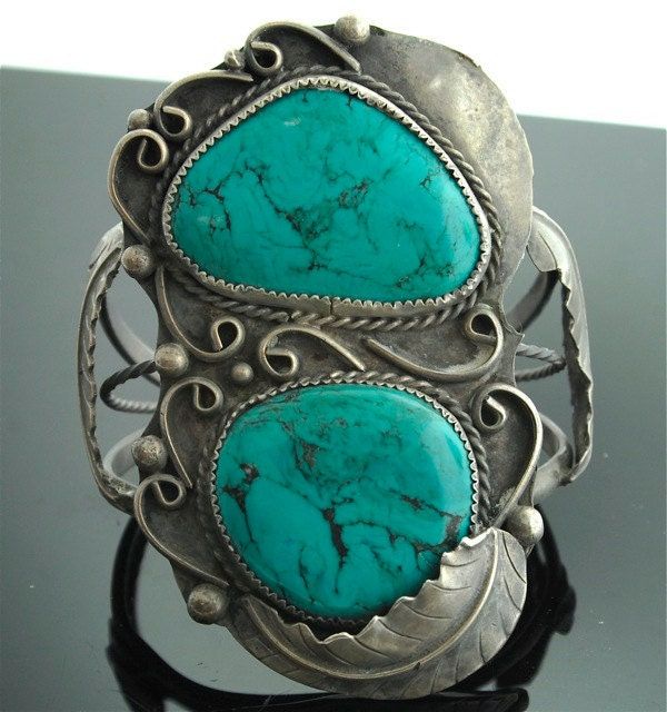 "Talk about a statement look! This vintage sterling silver and turquoise cuff bracelet is big and bold and fabulous. Two substantial sized turquoise stones are set in scalloped bezels with rope, swirl, & leaf details. What a wonderful to your jewelry collection. Sterling Silver Turquoise Cuff Bracelet Vintage Bracelet is 3 1/4\" inches wide by 2 1/4\" inches across Weighs 69.6 Grams Please read through our policies prior to purchase. Thank you for looking!" Lacy Clothes, Turquoise Bracelets, Turquoise Jewelry Native American, Navajo Jewelry, Turquoise Bracelet Cuff, Coral Jewelry, Turquoise Cuff, Sterling Silver Cuff Bracelet, Turquoise Stones