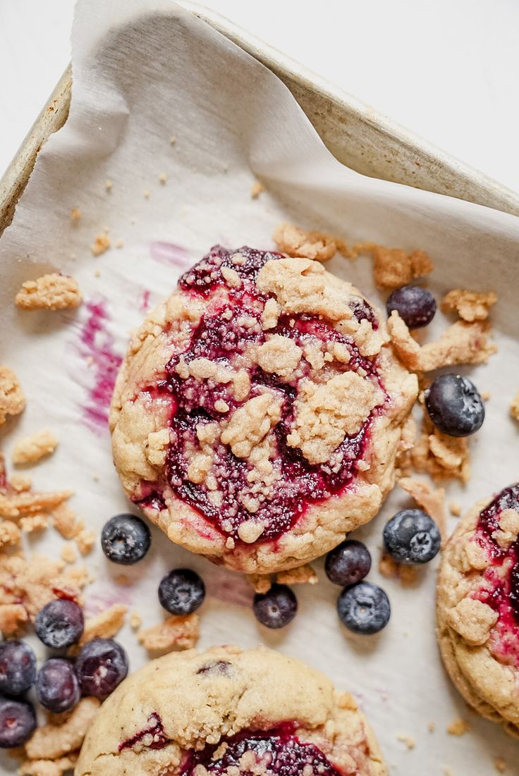 blueberry crumbs and cookies on a baking sheet